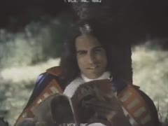 In a wilderness, a woman wearing a medieval outfit is drilled and struck.